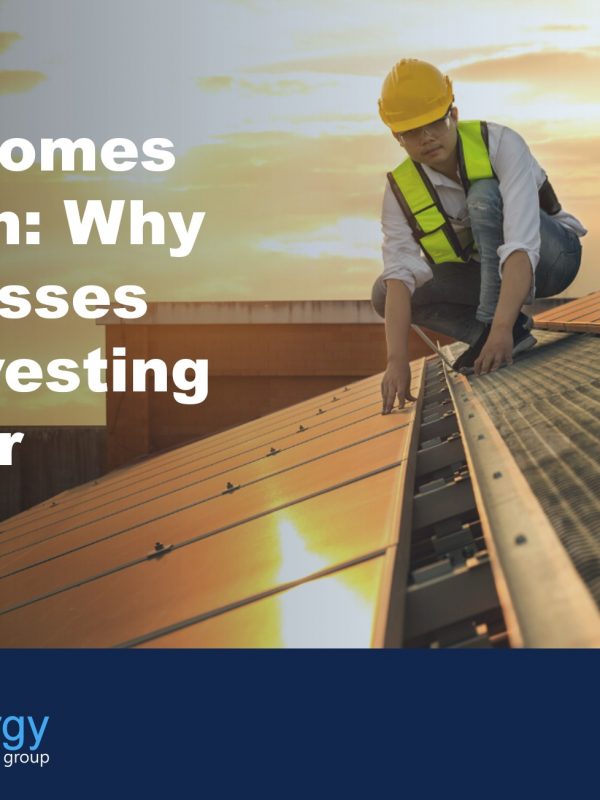 Image of person in high vis and hard hat on a roof installing solar panels, to illustrate the blog post about the benefits of solar panel leasing.