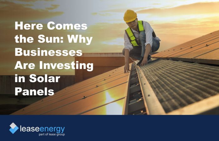 Image of person in high vis and hard hat on a roof installing solar panels, to illustrate the blog post about the benefits of solar panel leasing.